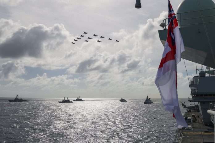 Pictured: US and UK F35B Lightning Jet and US F-18 fighter jets fly past in formation over (left to right) USS Chafee, JS Yamagiri, USS Lake Champlain, HMCS Winnipeg and HMS Defender. On 3rd October 2021, UK CSG Strike group, USS Carl Vinson Strike Group and the USS Ronald Reagan Strike group including the carrier JS ISE conducting a PHOTEX for Quad carrier ops in the Philippians sea. 17 ships were involved in the formation from United Kingdom, United States, Japanese, New Zealand, Canada all safely integrating and operating together developing interoperability and mutual understanding. There was also a flyby of US and UK F-35s and US F-18 jets to complete the PHOTEX.UK Carrier Strike Group 2021