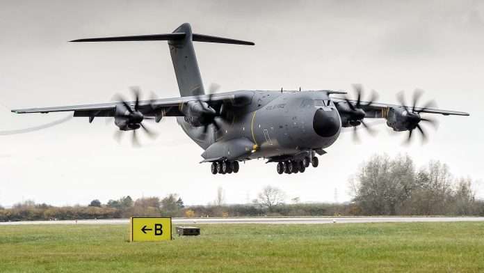 An RAF A400M Atlas transport aircraft coming in to land over grass at an airfield, file photograph