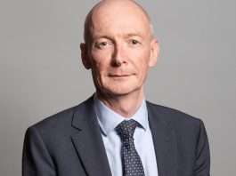 Pat McFadden, Work and Pensions Secretary, in a dark suit and patterned tie against a grey background