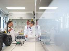 Labour’s £400bn AI claim came from a report commissioned by Google Keir Starmer and Peter Kyle in white lab coats talking with a researcher beside a robot vehicle and a drone in a laboratory at University College London East